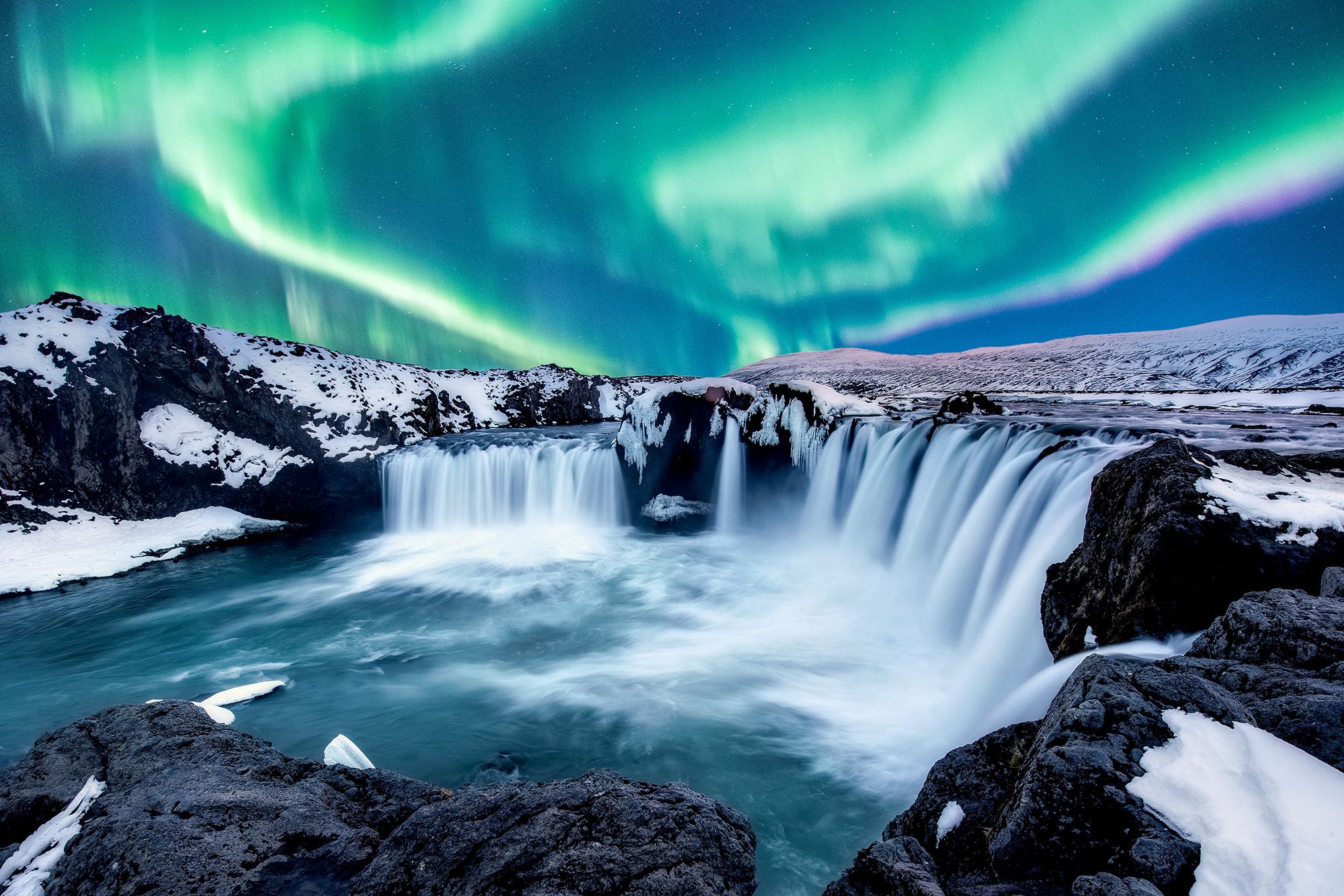 Iceland waterfall showing northern lights