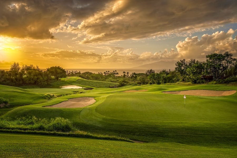 Sunset over the greens at The Plantation Course at Kapalua