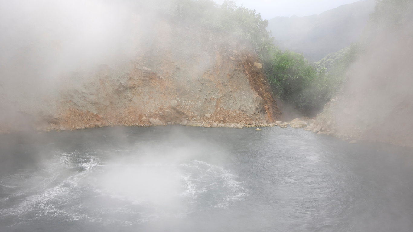 steam coming off of a boiling lake inside of a volcanic crater in Dominica