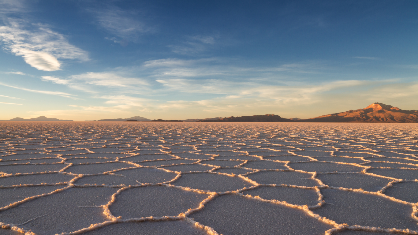 Salt flats with lines that have been caused by puddle of rain with the Andes mountains in the background in Bolivia