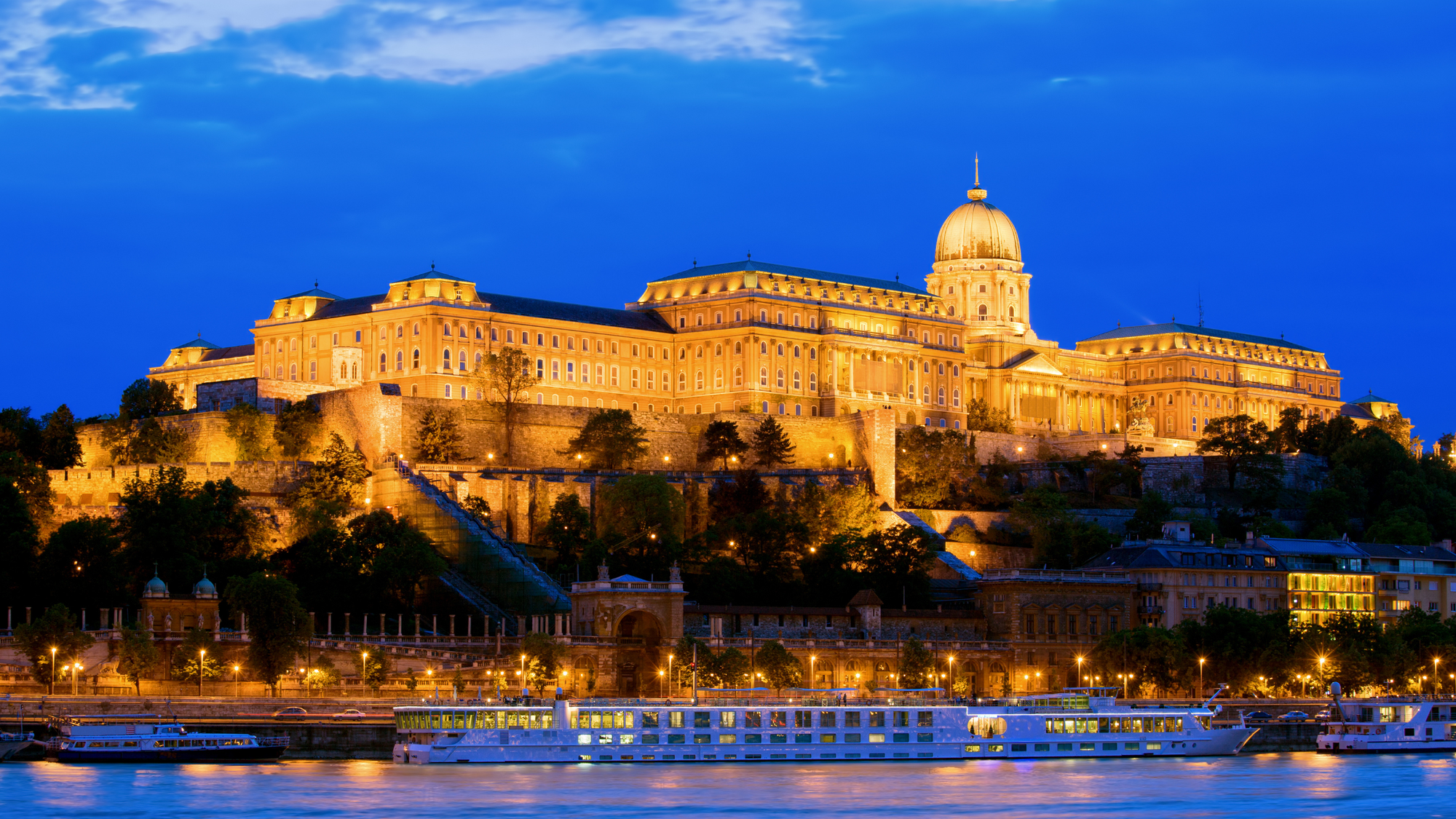 Buda Castle in Budapest, Hungary, with its grand Baroque architecture perched on Castle Hill overlooking the Danube River.