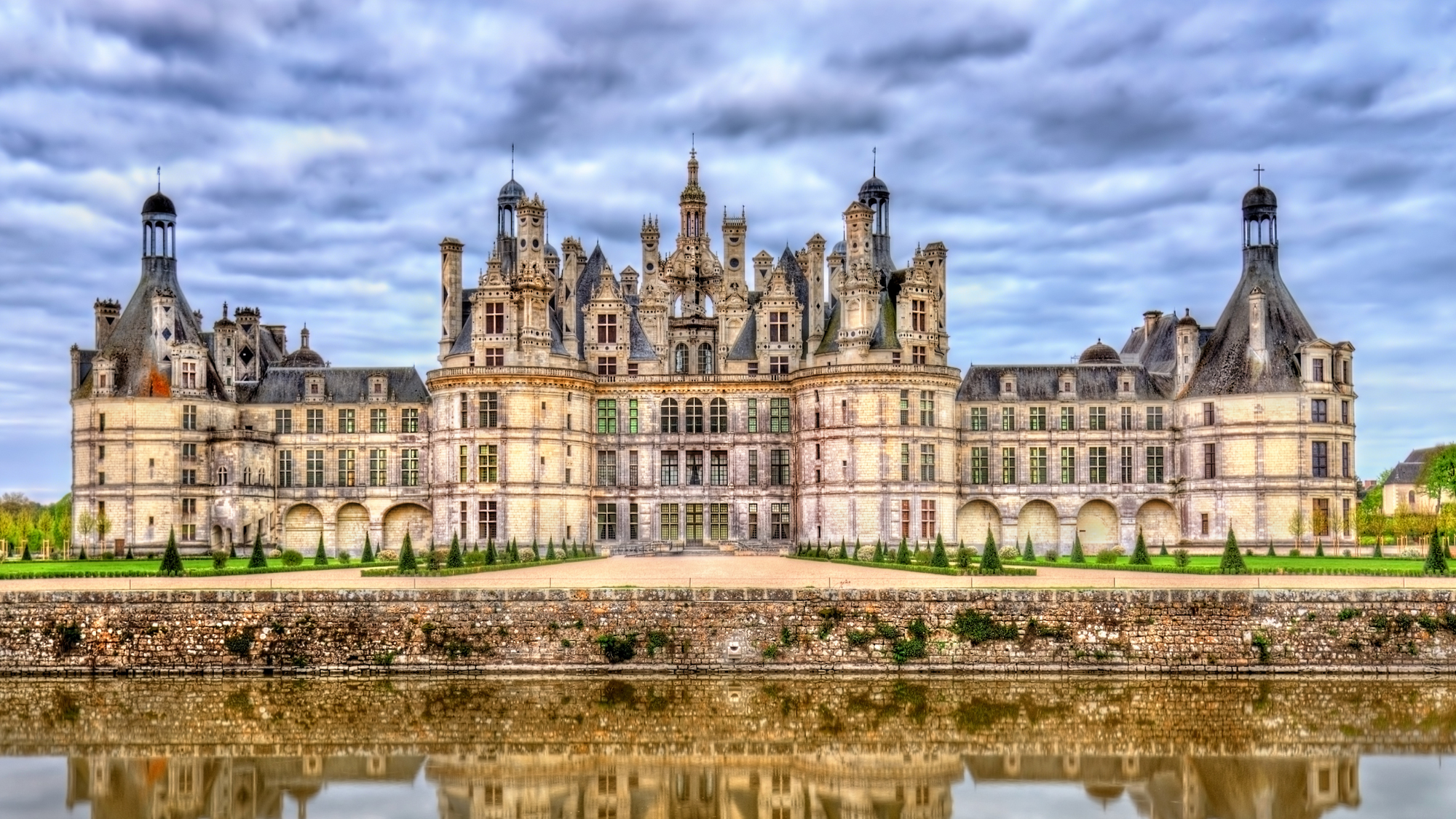 Château de Chambord in France, showcasing its grand Renaissance architecture with ornate towers and a reflective moat.