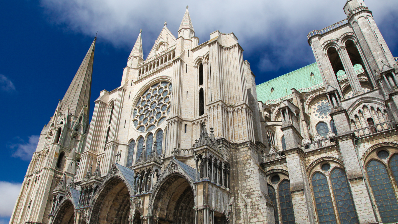 looking up at the Chartres Cathedral with clear blue skies showing above it