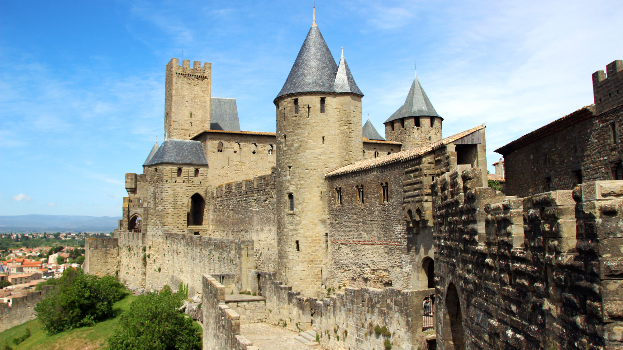 Cité de Carcassonne in France, a fortified medieval city with high stone walls and numerous watchtowers.