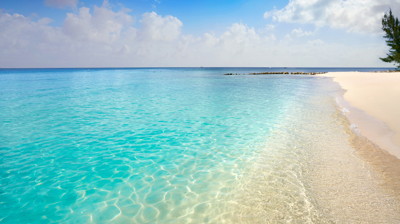 crystal clear Caribbean blue calm water leading up to a white sand beach at El Cielo in Cozumel Mexico