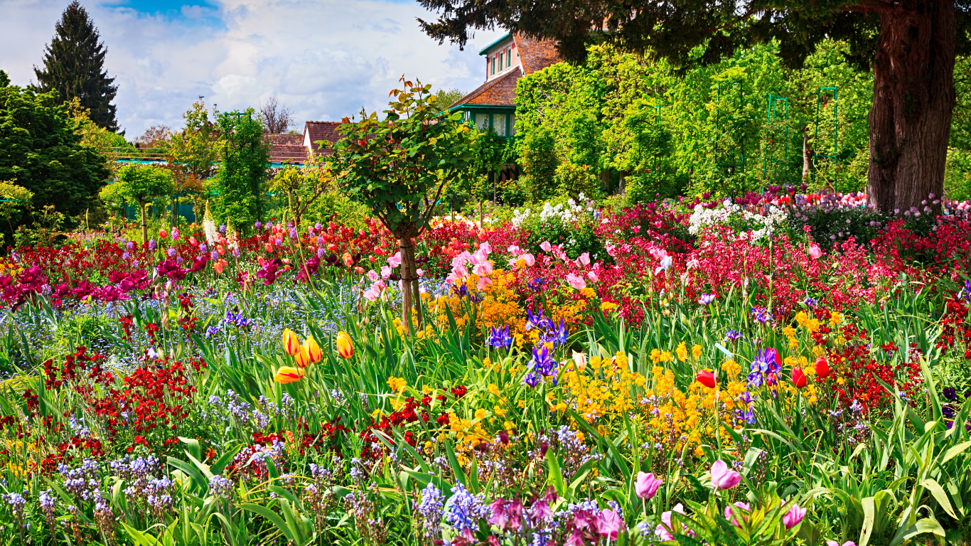 red, blue, purple and orange flowers in Giverny, France home of Claude Monet house