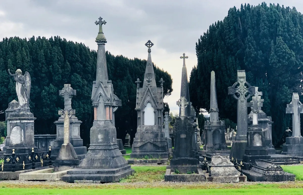 tomb stones at Glasnevin Cemetery Museum in Dublin Ireland with Celtic crosses on top and other 17th century styles