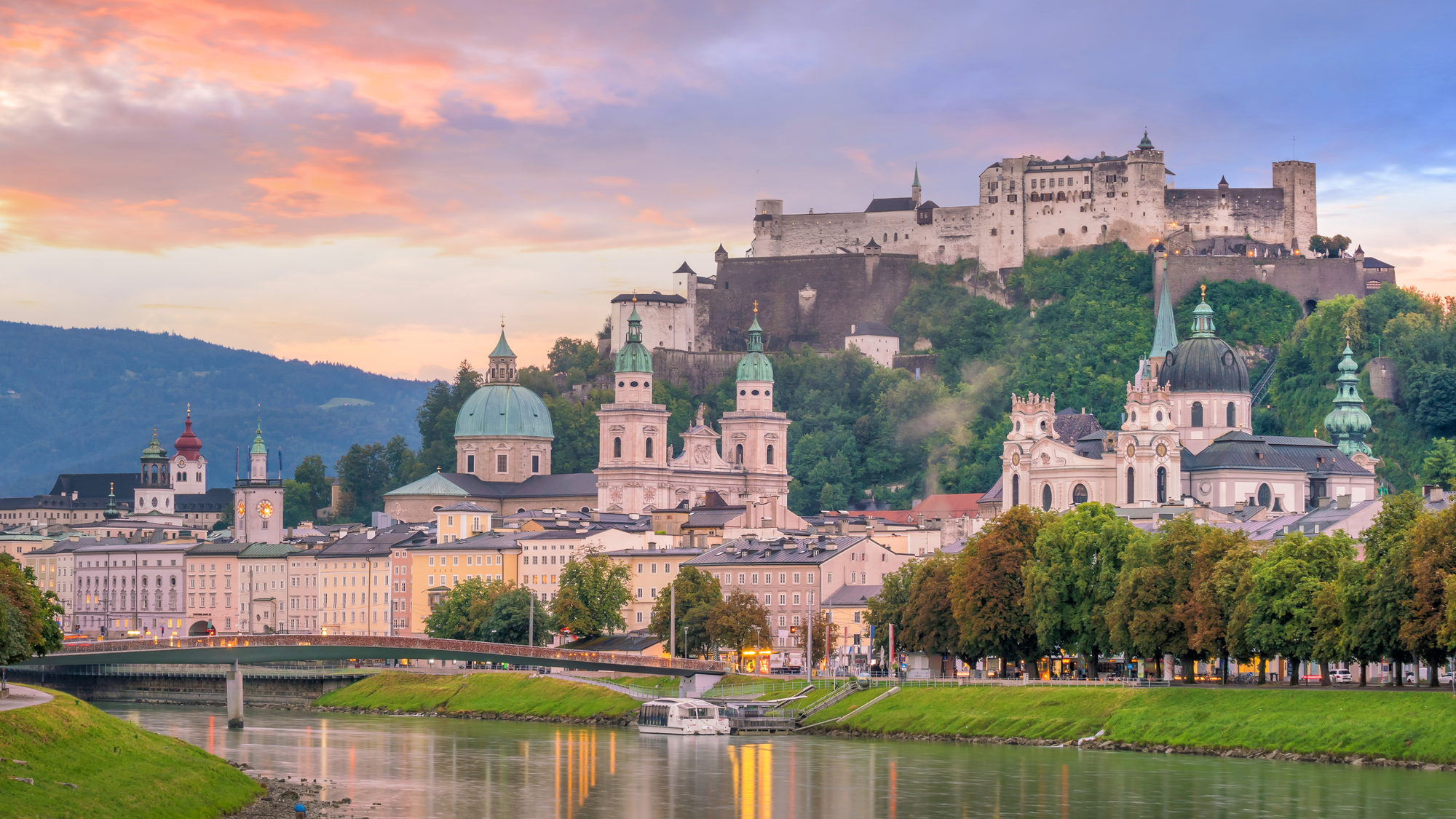 Hohensalzburg Castle in Salzburg, Austria, sitting atop a hill with its white stone walls and medieval towers