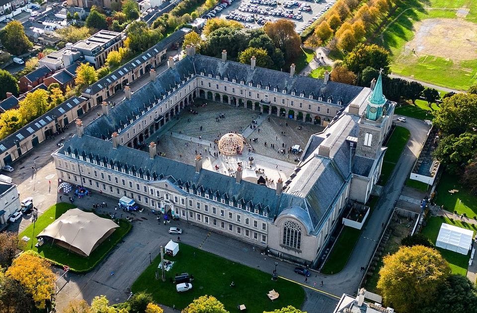 Airel View of a two story square complex that has a courtyard in the center that looks like a building built in the 1800's