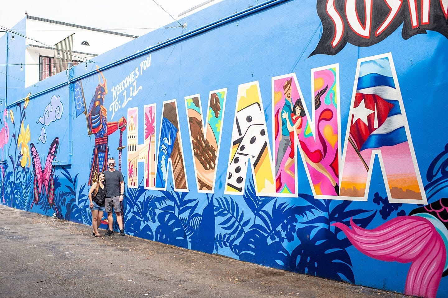 Bright and colorful mural in Little Havana, Miami, featuring bold letters spelling out 'Havana' and vibrant imagery reflecting Cuban culture, with a couple posing in front.