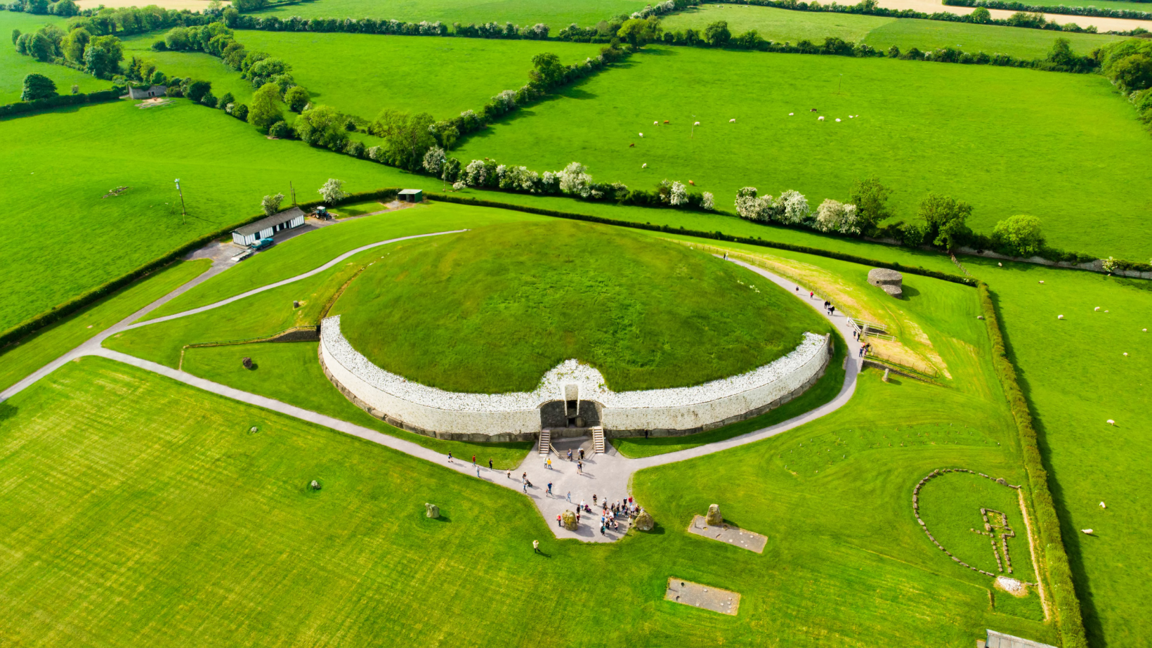 green grass growing on top of a structure Newgrange and the Boyne Valley 