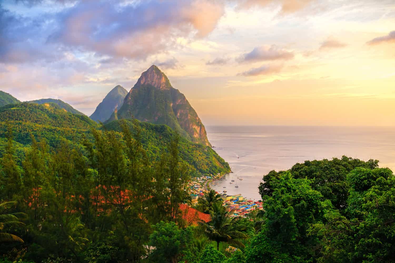 Two mountain peaks surrounded by jungle on the ocean front in St. Lucia.