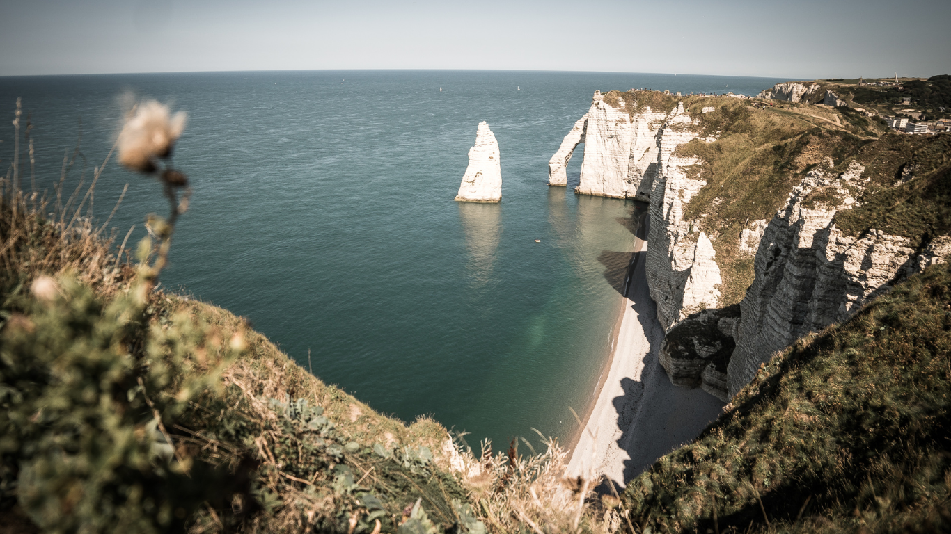 Plage d’Étretat aerial view beach view with it's jagged cliffs and needle like formations coming out of the sea