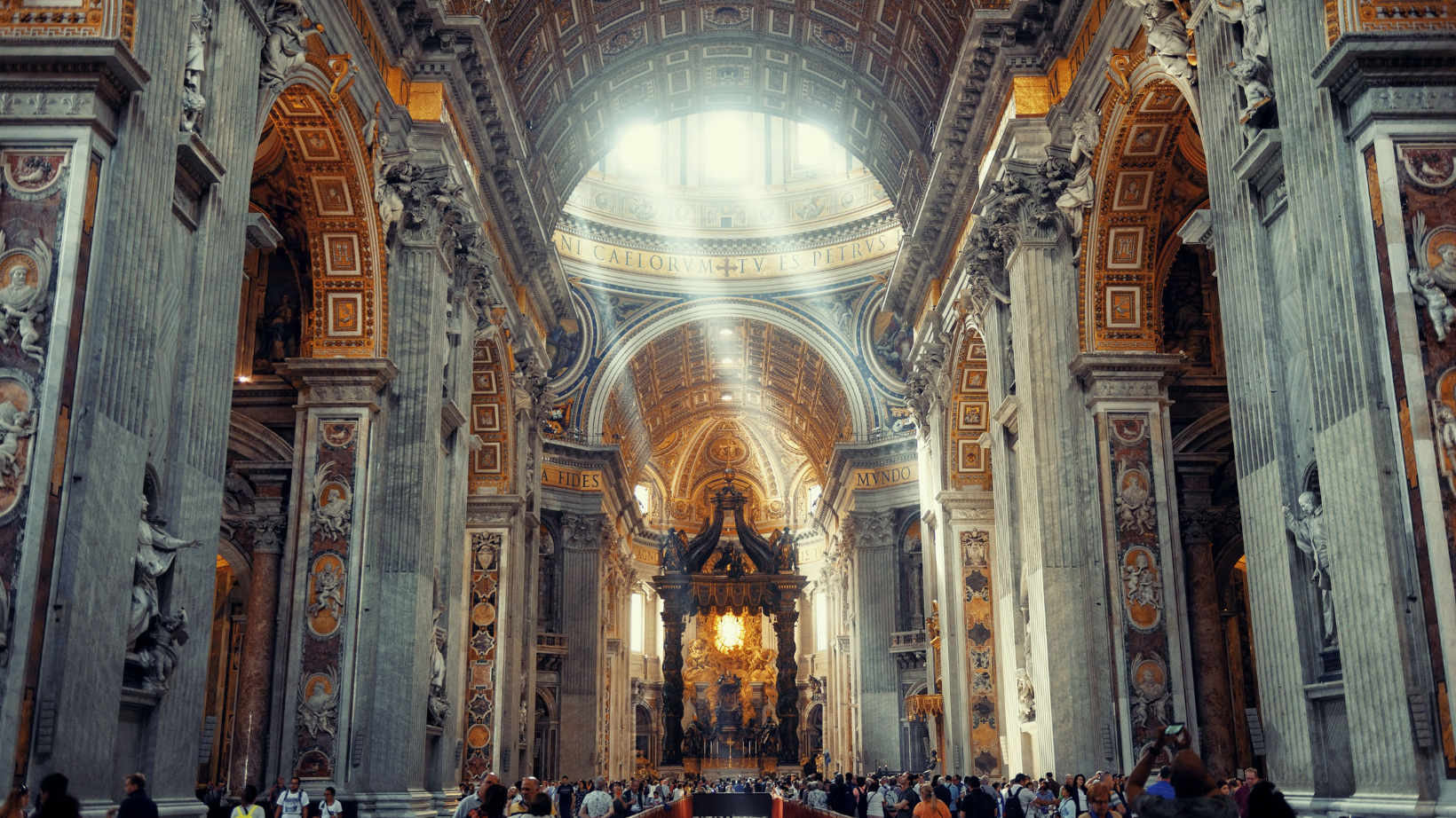 Inside St. Peter's Basilica In Rome with sun shining through the windows