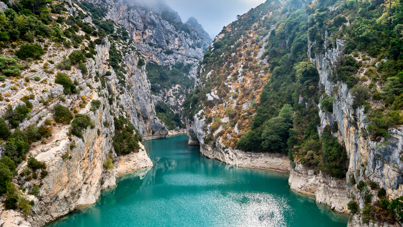 emerald green water surrounded by cliff at Verdon Gorge