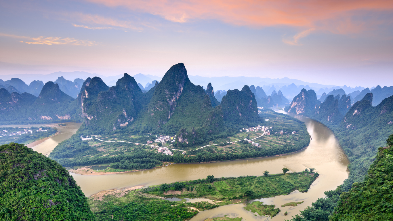 River running through the lush bright green valleys of the mountainous Zhangjiajie National Forest Park in China.