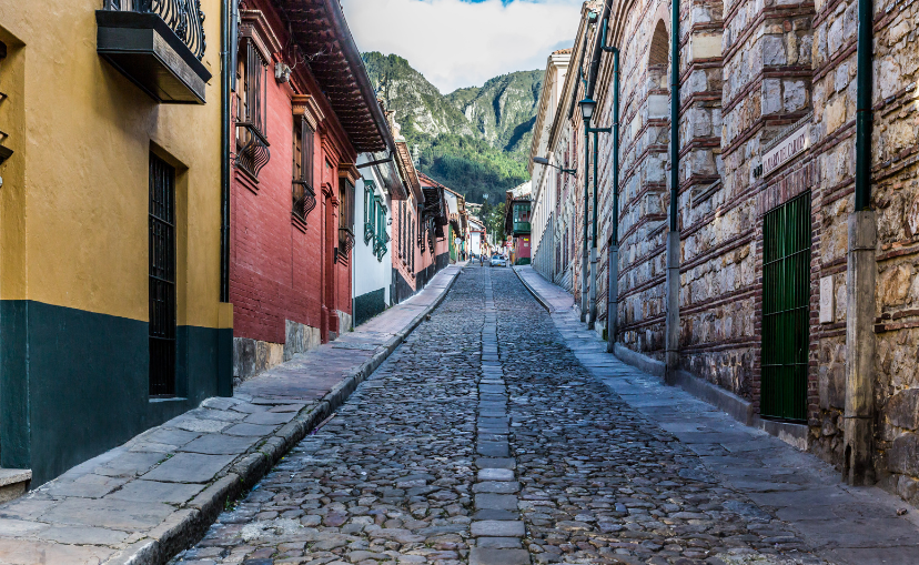 La Candelaria colorful Streets in Bogota Colombia has cobblestone streets and bright colored buildings along the street