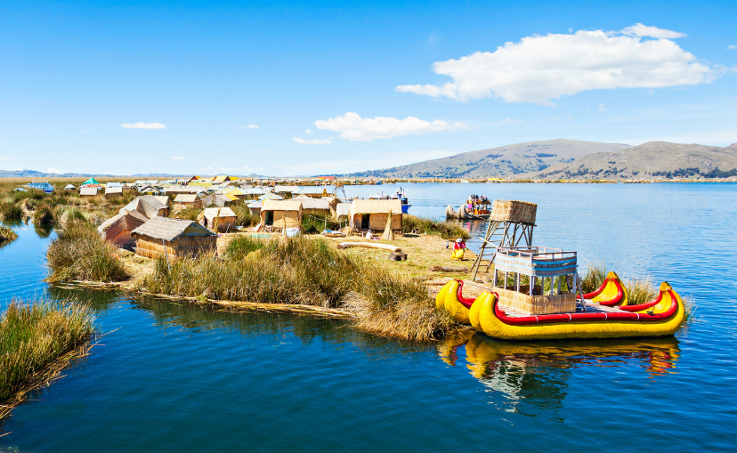 Floating houses on lake Titicaca, and a floating colorful pontoon boat