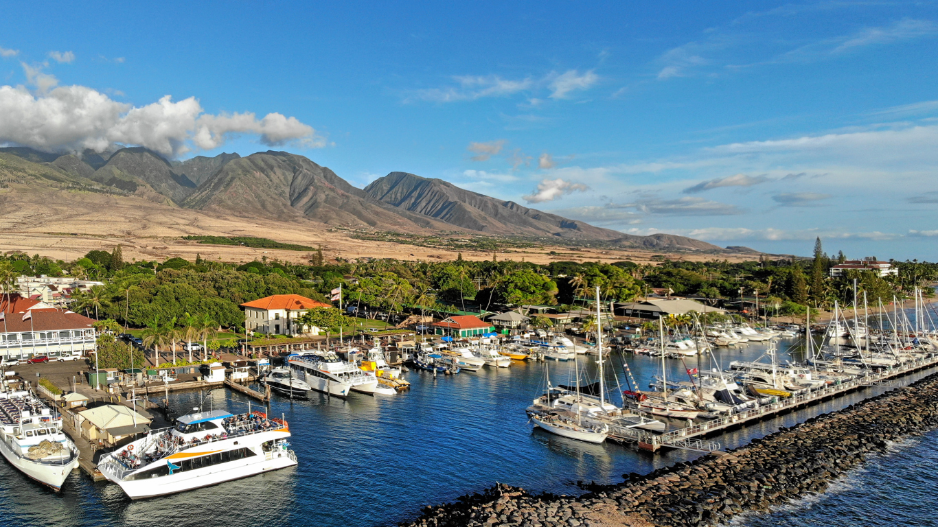 boats docked with mountains in the background at Maalaea Harbor, in Maui, Hawaii