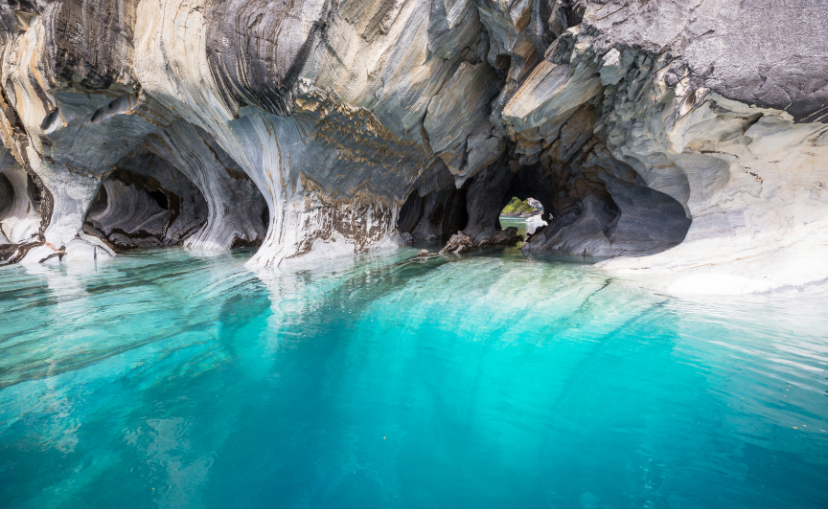 Clear blue waters in the center of white marble walled caves at General Carrera Lake in Chilean Patagonia