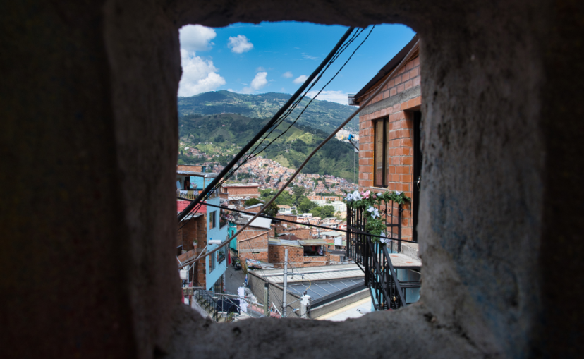 Cable car elevator located in Commune 13 Medellin, Colombia seen through a old rock window in the wall.