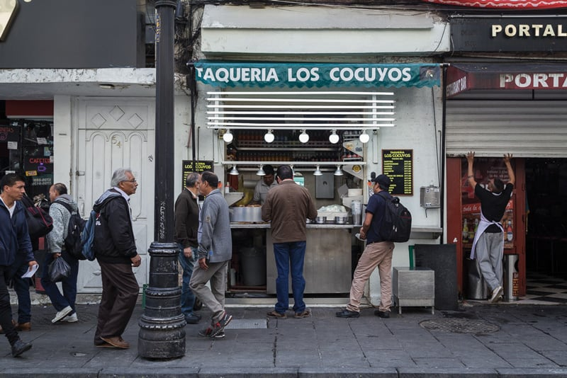 people waiting for food outside at a street food diner