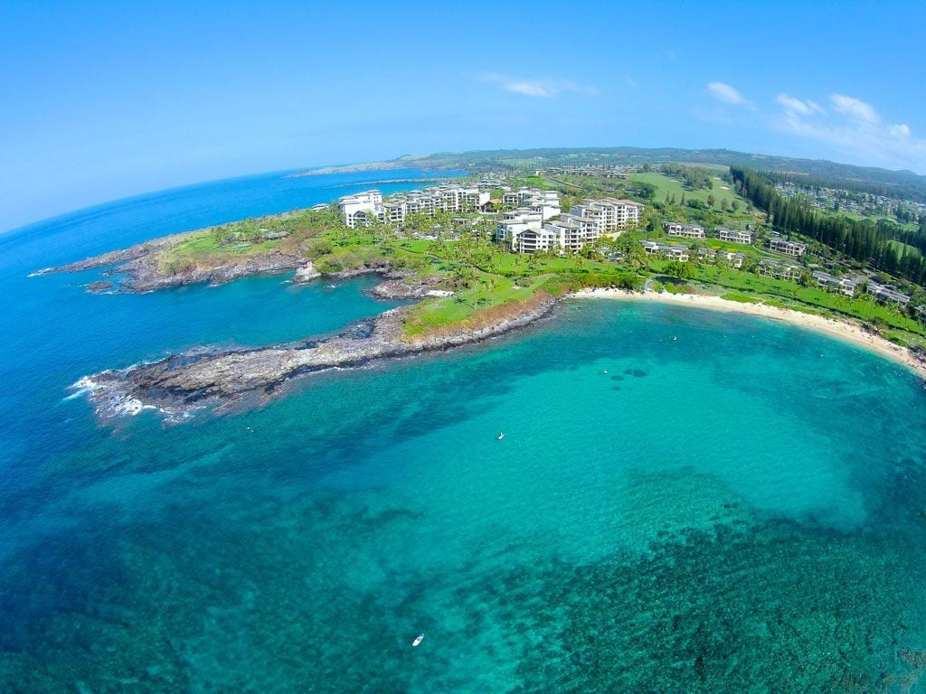 Ariel view of Kapalua Bay with clear blue waters and white sandy shores