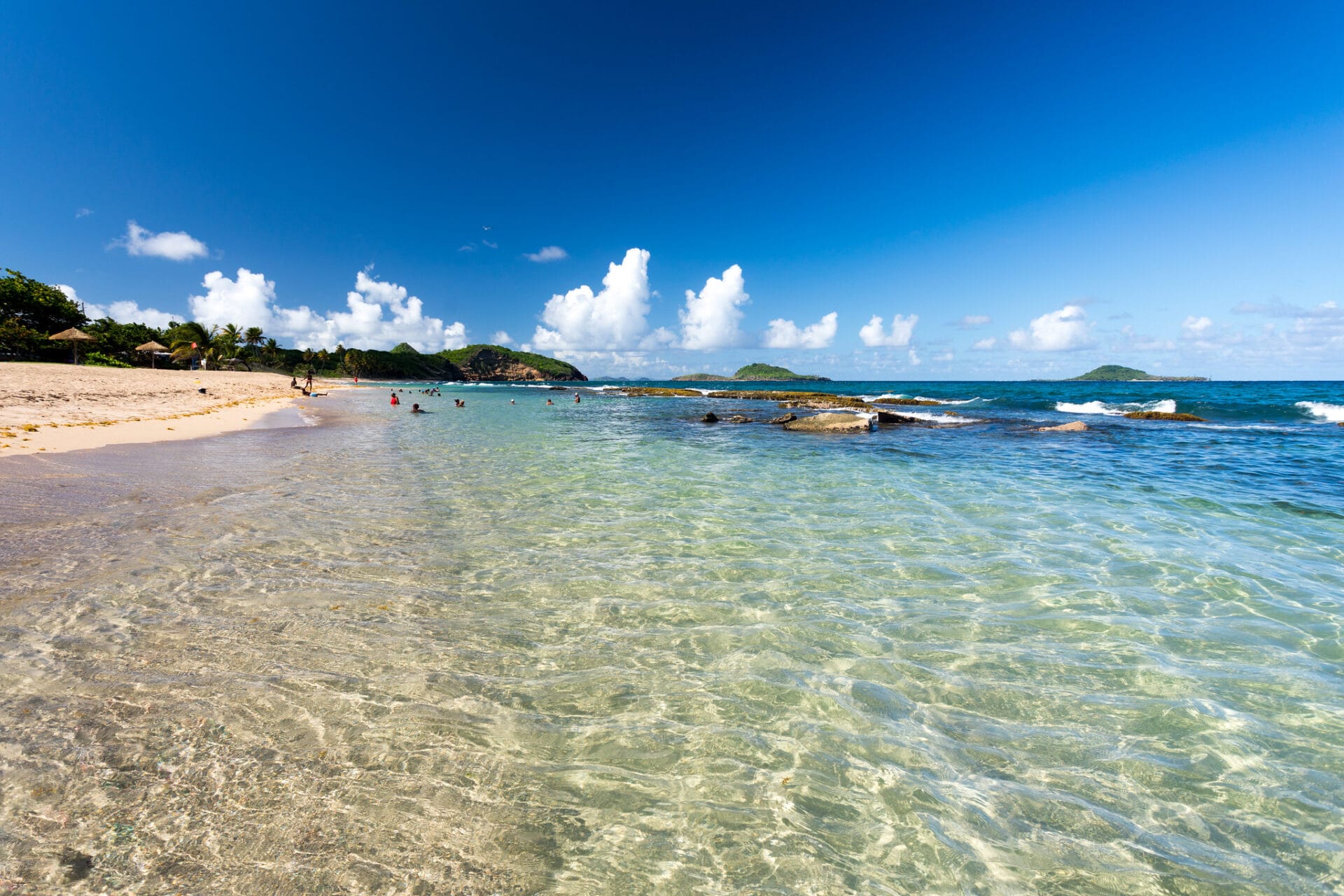 Crystal clear waters with people swimming near white sandy beaches - Bathway Beach Grenada