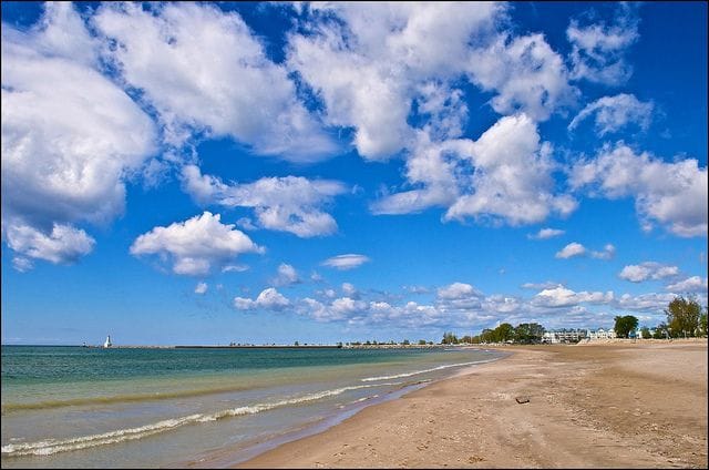 waves washing on to a long beach at Cobourg Beach in Cobourg, Ontario