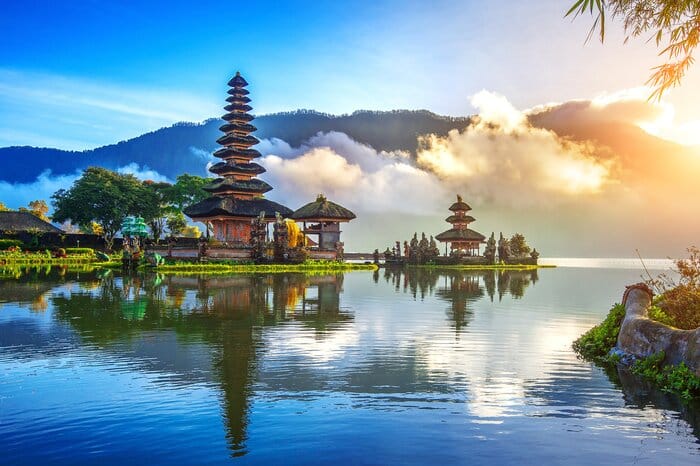 Temple on a Lake in Bali, Indonesia with clouds nearly touching the lakes waterfront