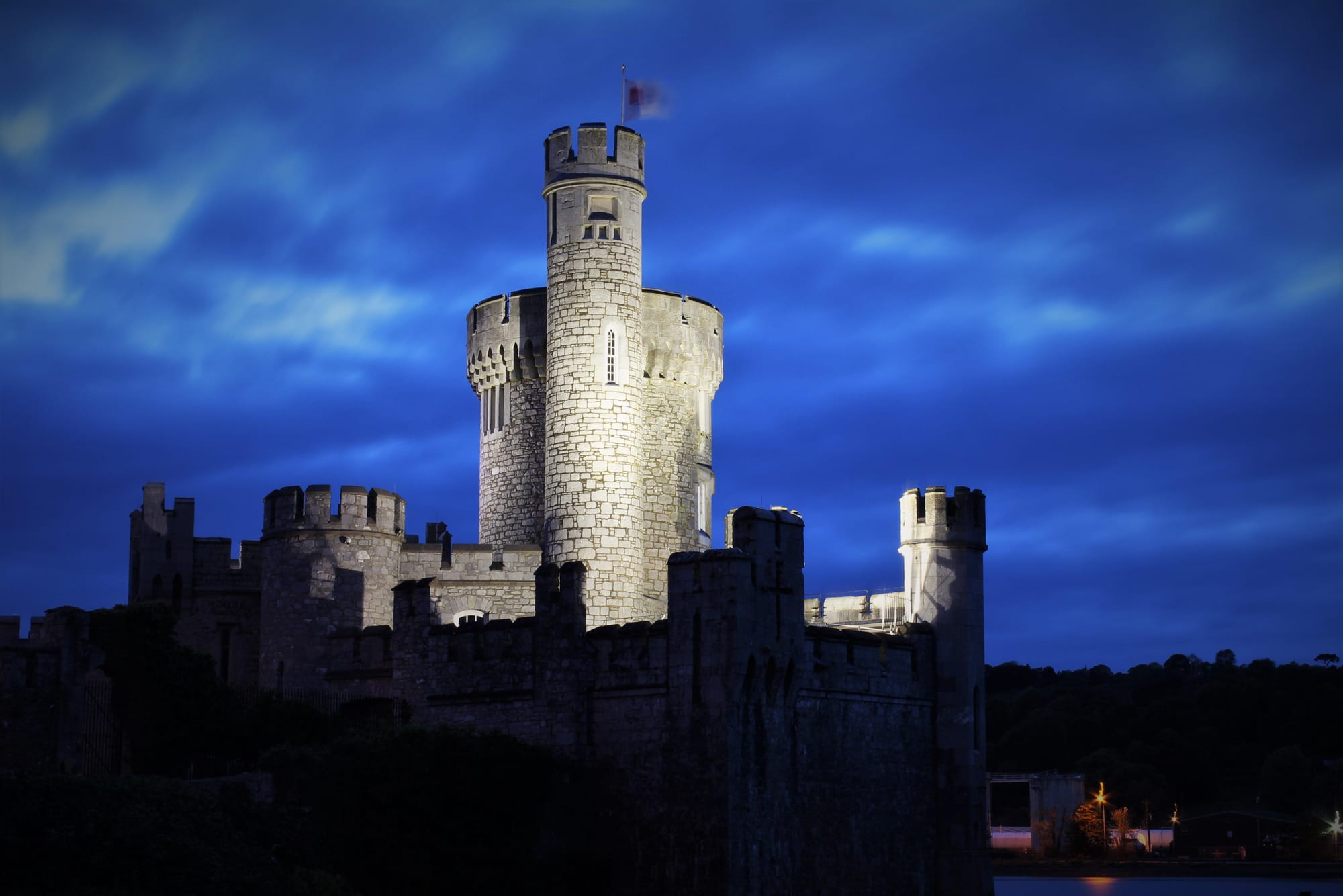 The Blackrock Castle appears as a well preserved Castle lit up by lights at nighttime in Cork, Ireland