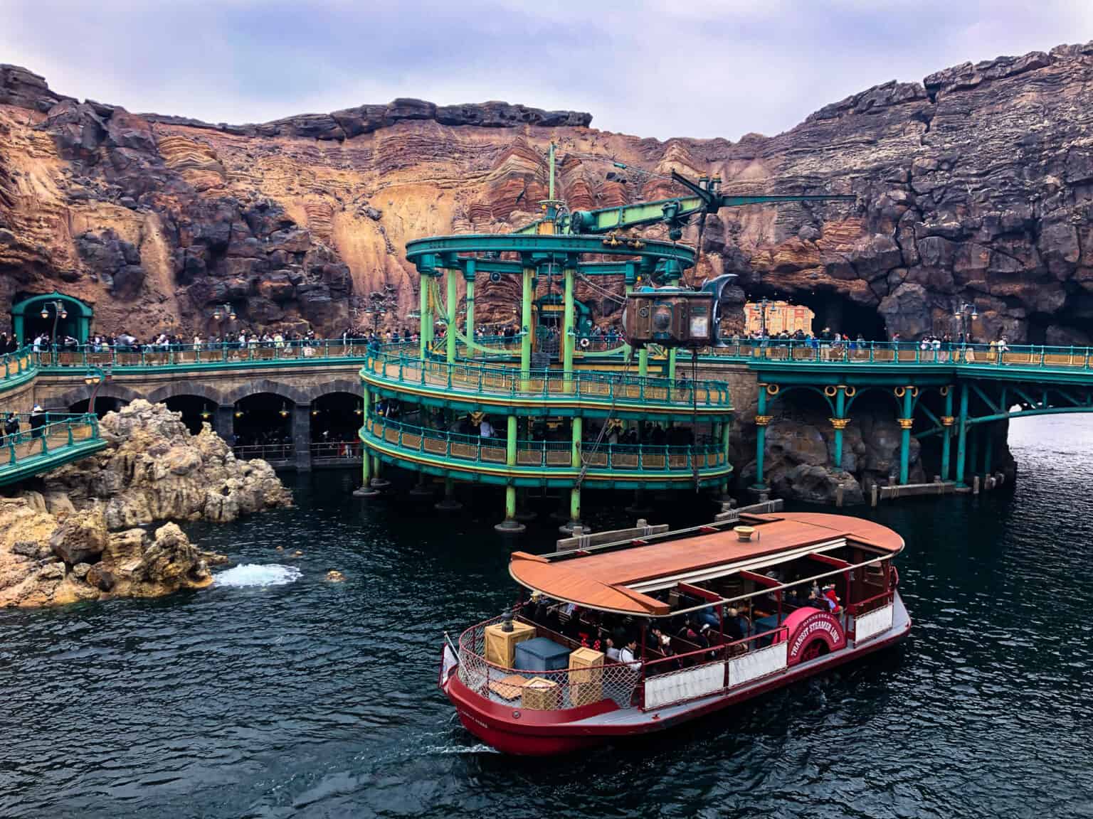 A boat carrying theme park passengers through a water way at DisneySea in Tokyo's DisneySea 