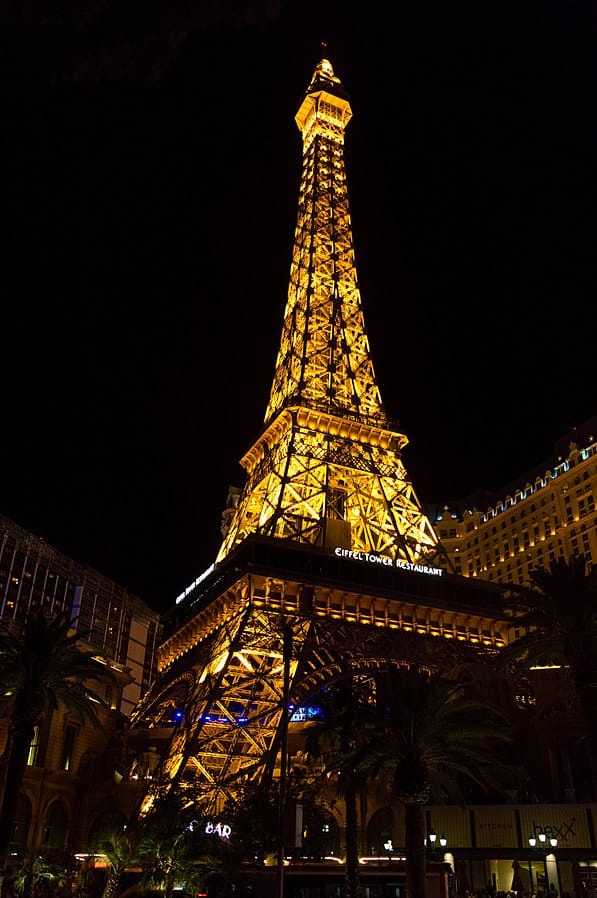 Visit the Eiffel Tower at Paris Las Vegas At Night lit up with orange lights.