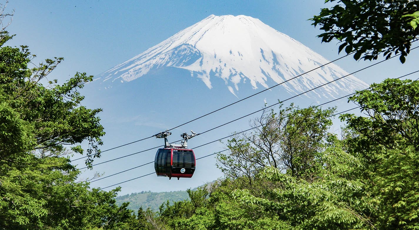 A cable car going up a mountain offering amazing views of Mt. Fuji in Tokyo, Japan.