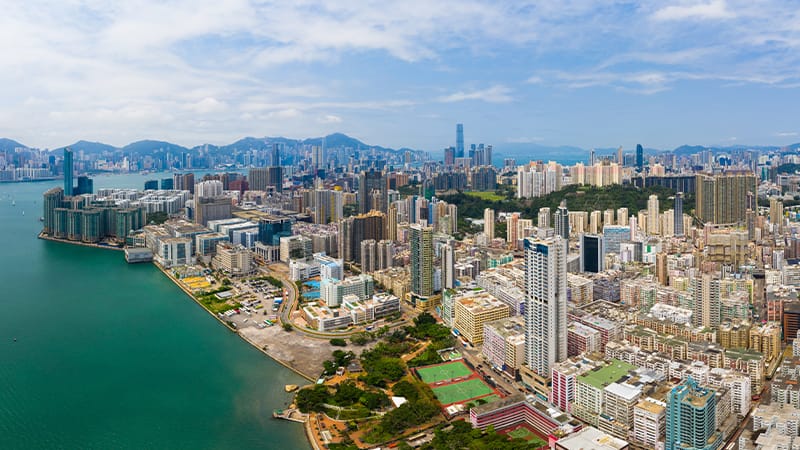 Ariel view of a bay that has towering buildings lining it's water front. 