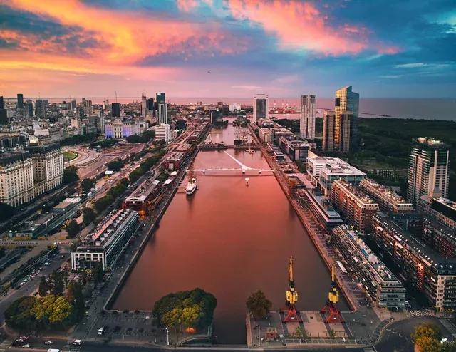 Ariel view of a canal running through Buenos Aires with high-end apartment buildings lining the waterfront in the Puerto Madero Neighborhood