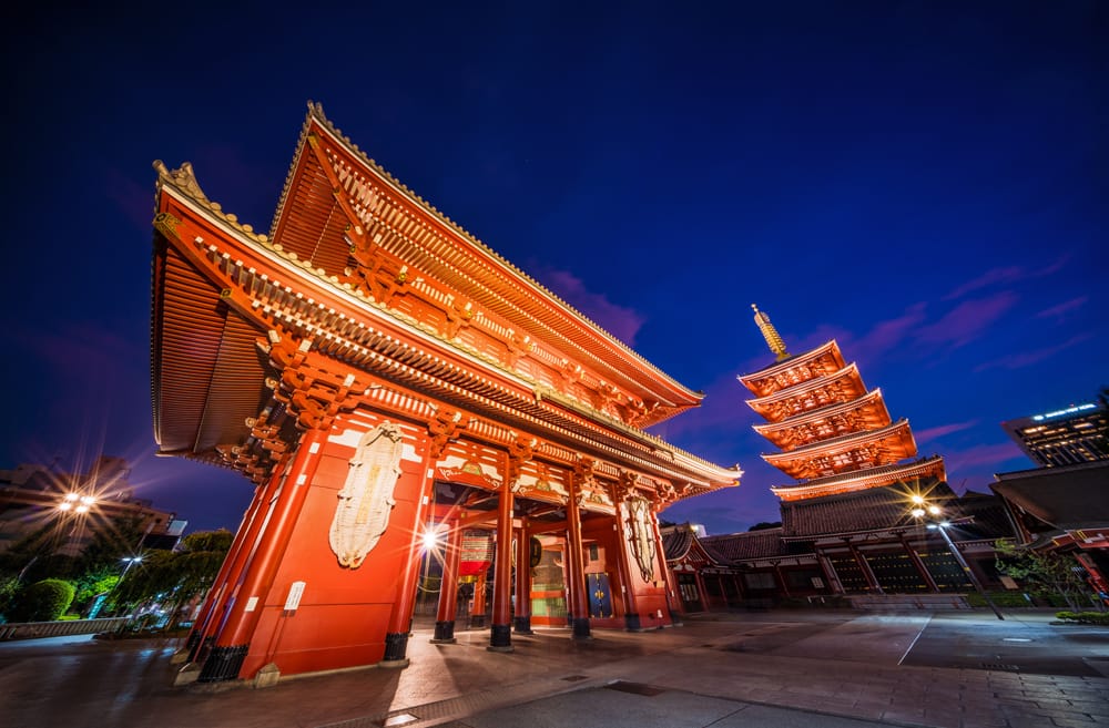 Japanese temple at nighttime lit up with red lights at  Senso-ji Temple