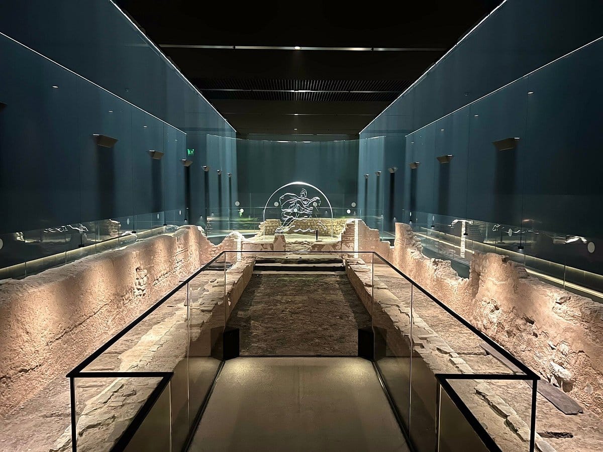 Archeological site that has been turned into a museum with glass case protecting the site. 