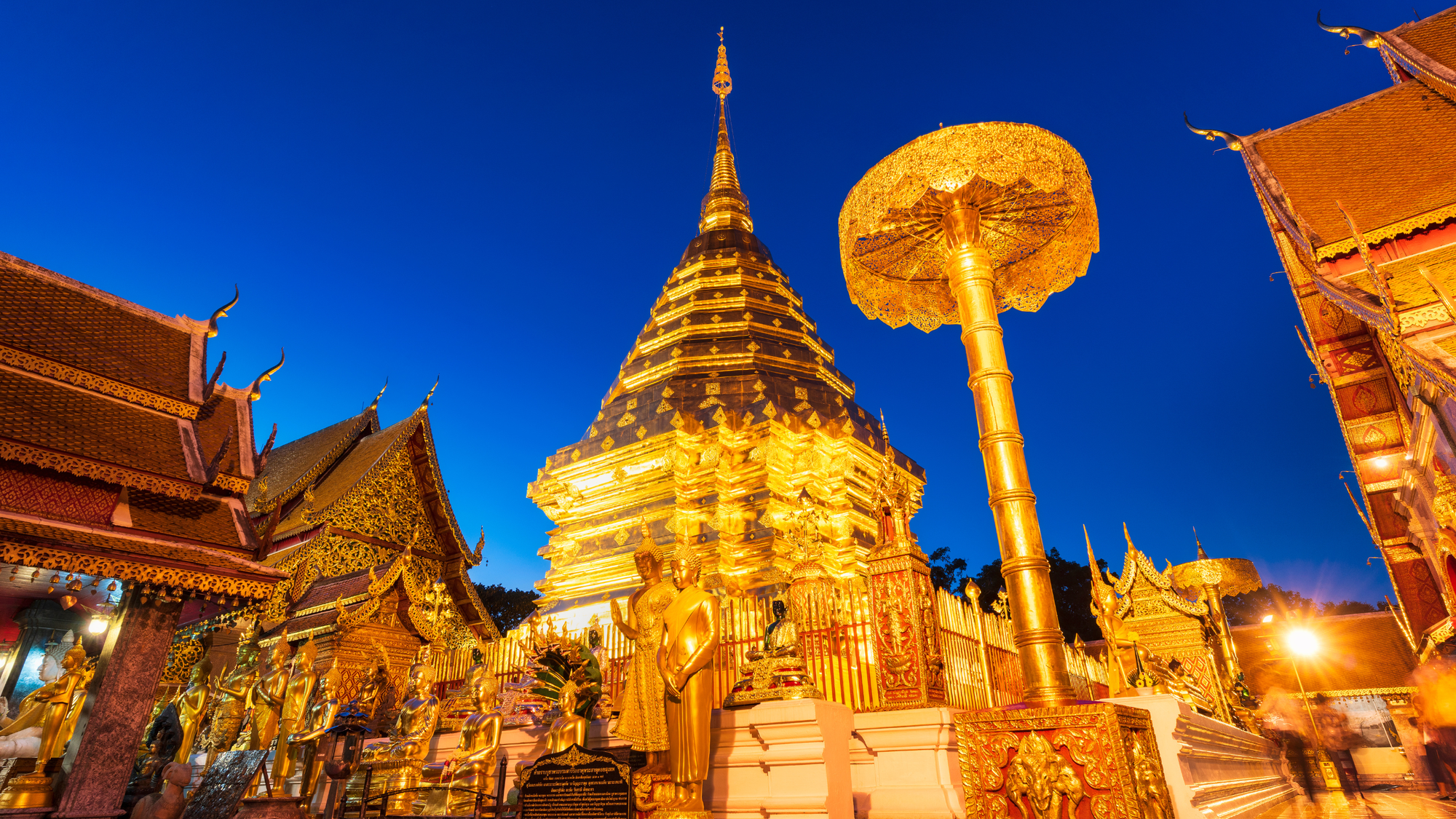 inside of a temple complex where all of the interior as well as the temples are a bright shiny gold color. 