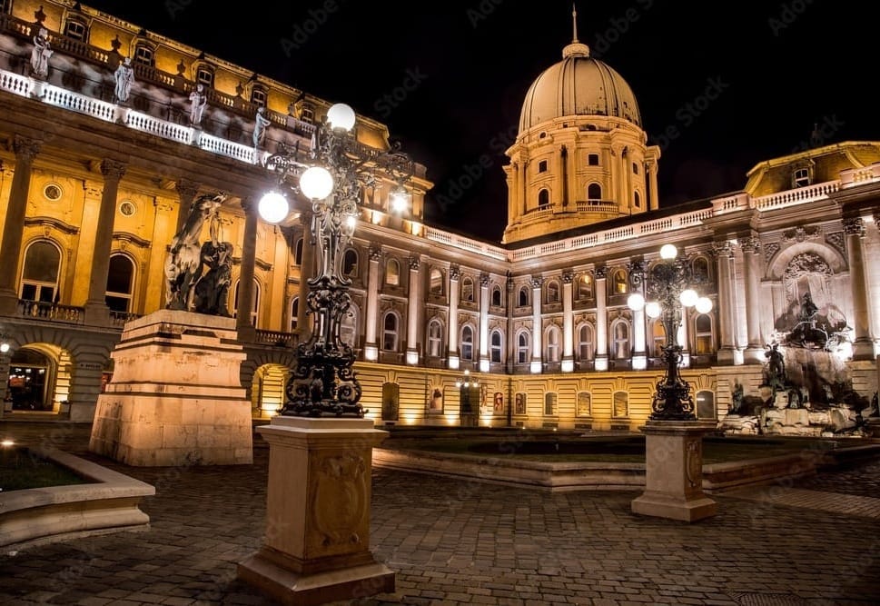 Lights lighting up Buda Castle at nighttime in Budapest, Hungary