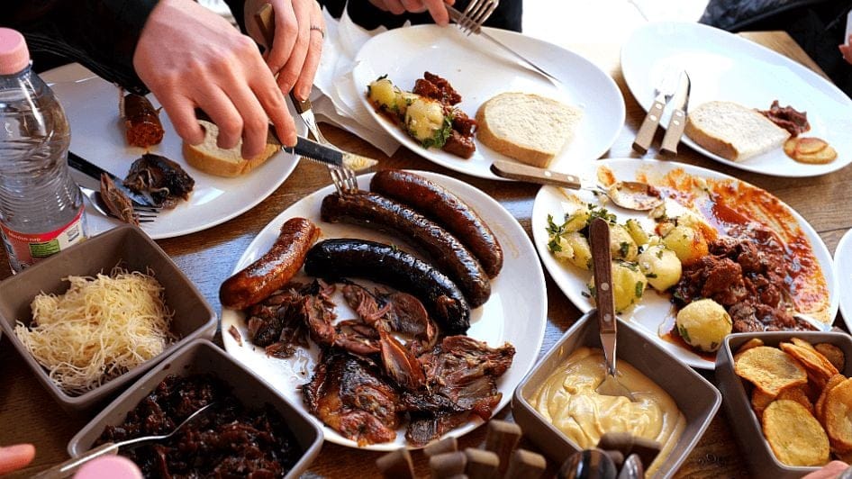 A table with sausages, other meats and breads at a cafe in Budapest. 