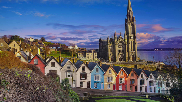 Colorful houses and a cathedral sitting on the River Lee on a nice sunny day in Cork, Ireland. 