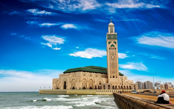 A man sitting near the edge of the ocean in Casablanca, Morocco