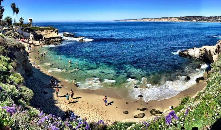 people playing on the beach at La Jolla Cove San Diego, California.